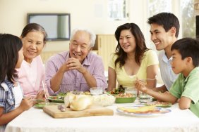 A mulit-generational family of Asian-Americans sharing a meal